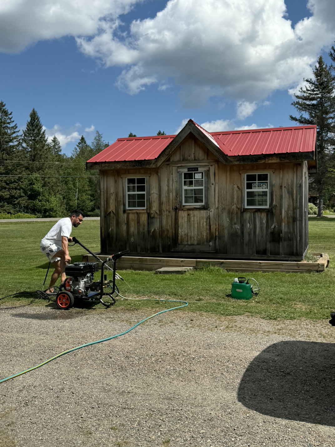 Shed before power washing — dark weathered wood